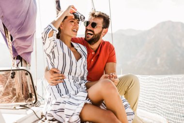 Sevgi dolu çift denizde yatta mutlu vakit geçiriyor. Deniz kenarında lüks bir tatil.. 