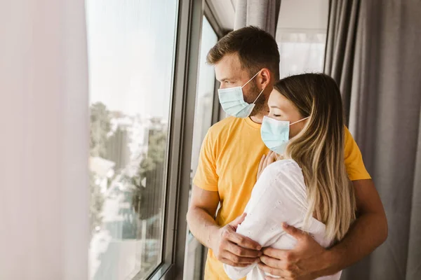 Young Couple Isolation Wearing Mask Standing Window — Stock Photo, Image