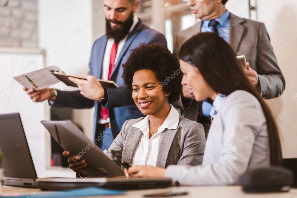 Multi-ethnic group of happy business people having a meeting in modern office.