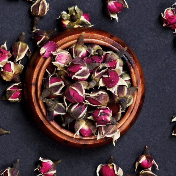 Arrangement Small Dried Rose Buds Tea Wooden Jar Closeup Black — Stock Photo, Image
