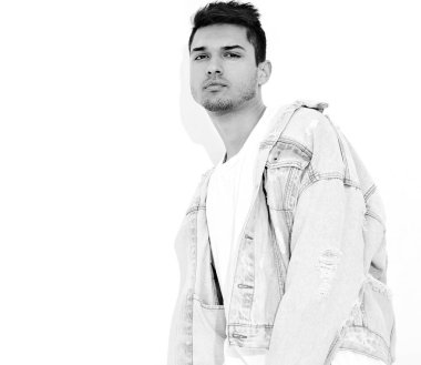 Yakışıklı genç model adam portresi beyaz arka plan üzerinde poz kot elbise giymiş. İzole