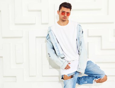 Yakışıklı genç model adam portresi beyaz dokulu duvar poz kot elbise giymiş