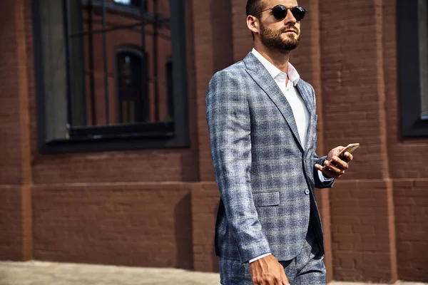 性感英俊的时尚商人的肖像穿着优雅的格子西装 在智能手机上的商业移动交谈在街上 型男步行 — 图库照片
