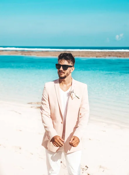 Porträtt Stilig Brudgum Rosa Kostym Poserar Stranden Bakom Blå Himmel — Stockfoto