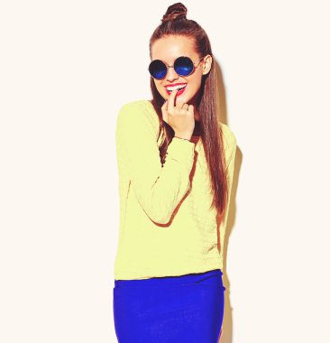 portrait of cheerful fashion smiling hipster girl going crazy in casual colorful yellow summer clothes with red lips isolated on white biting her finger clipart