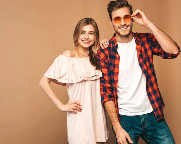 stock image Portrait of Smiling Beautiful Girl and her Handsome Boyfriend laughing.Happy Cheerful Family. in sunglasses.Valentine's Day. Posing on beige wall. Hugging