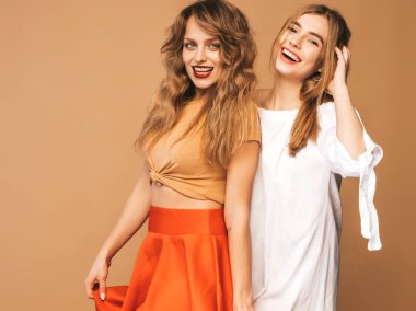 İki genç güzel gülümseyen hippi kız trendy yaz giysileri. Seksi kaygısız kadın Studio altın arka plan üzerinde poz. Olumlu modelleri