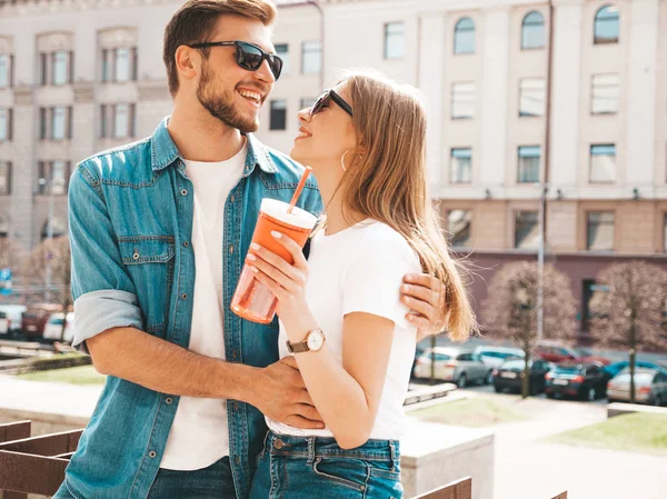 stock image Smiling beautiful girl and her handsome boyfriend in casual summer clothes. Happy cheerful family having fun on the street background in sunglasses