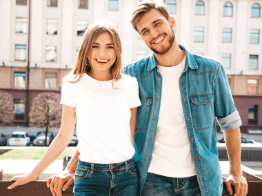 Gülümseyen güzel kız ve yakışıklı erkek arkadaşının portresi. Günlük kot pantolon giymiş bir kadın. Mutlu, neşeli bir aile. Sokakta eğlenen bir kadın.