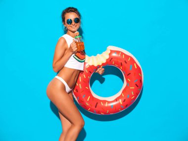 Güneş gözlüğü genç güzel seksi gülümseyen hipster kadın. Beyaz yaz külot kız ve donut lilo şişme yatak ile konu. Pozitif kadın deliriyordu. Mavi duvarın yakınında poz vermek