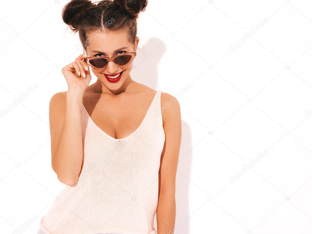 Young beautiful woman looking at camera. Trendy girl in casual summer  clothes showing. Positive female shows facial emotions. Funny model isolated on white.Takes off sunglasses