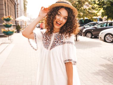 Yaz hipster beyaz elbise giymiş afro bukleler saç modeli ile güzel gülümseyen model portresi. Seksi kaygısız kız sokak arka planda poz. Şapka trendy komik ve pozitif kadın