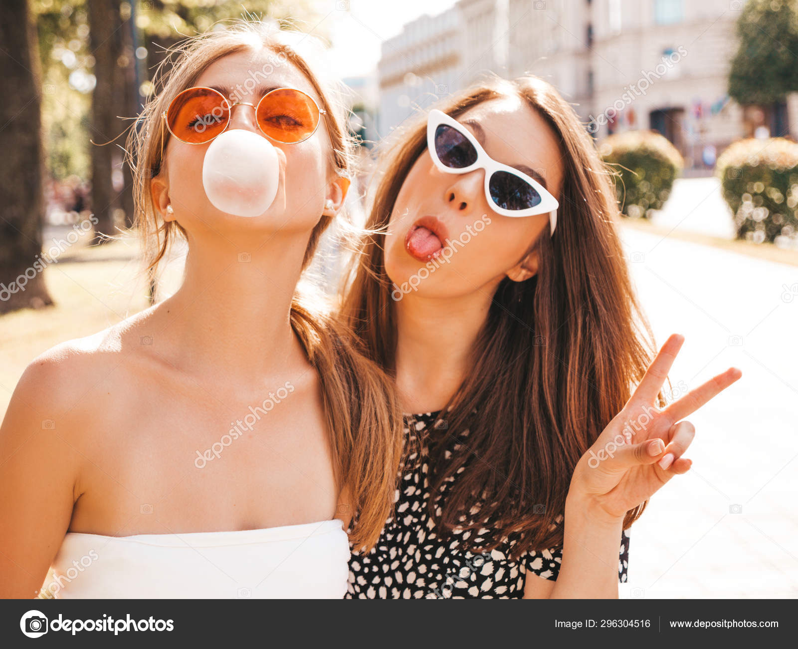 Free Photo  Two young beautiful smiling hipster girls in trendy summer  clothes.sexy carefree women posing on street background in sunglasses.  positive models having fun and hugging