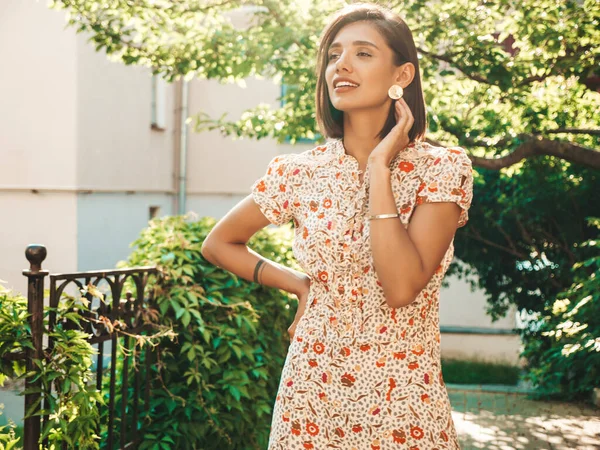 Portrait of young beautiful smiling  woman in trendy summer sundress.Sexy carefree woman posing on the street background at sunset. Positive model outdoors