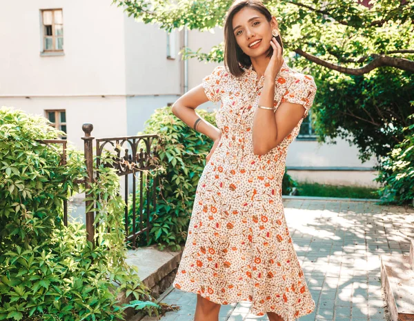 Portrait of young beautiful smiling  woman in trendy summer sundress.Sexy carefree woman posing on the street background at sunset. Positive model outdoors