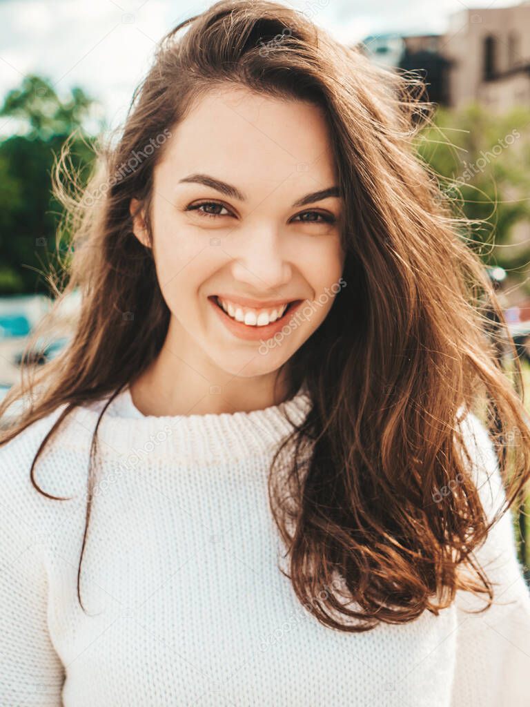 Closeup portrait of beautiful smiling brunette model. Trendy female posing in the street background. Funny and positive woman having fun outdoors