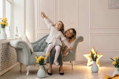 Anne uçakta kızıyla oynuyor.