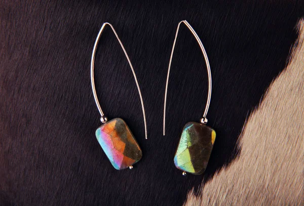 silver earrings labradorite stone wool background