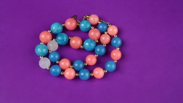 agate stone silver beads purple background hd footage