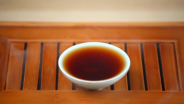 Black Hot Chinese Tea Cup Bamboo Desk Footage — Stock Video