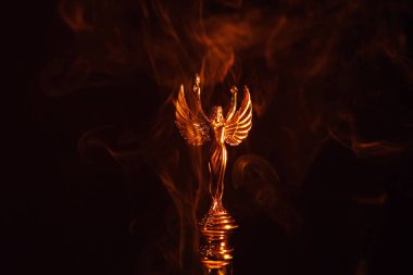 gold angel statue smoke dark background  clipart
