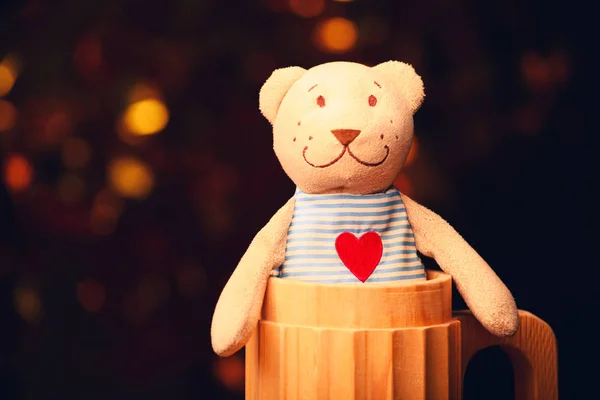 wool toy bear red heart wooden glass gold bokeh studio