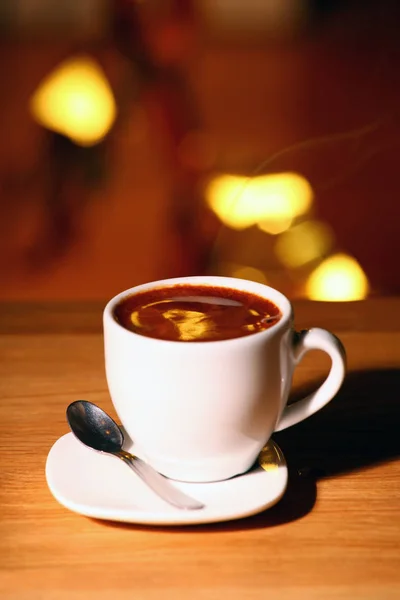 One Hot Coffee Cup Spoon Wooden Table Gold Bokeh Nobody — Stock Photo, Image