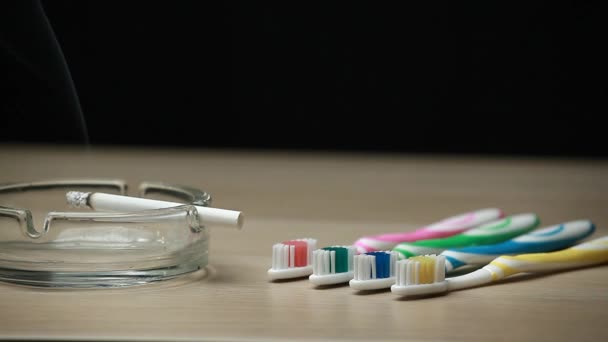 Toothbrush Cigarette Wooden Table Dark Background Nobody Footage — Stock Video