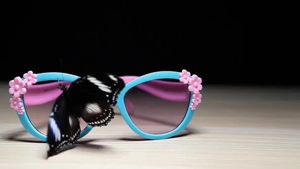 Sunglasses Butterfly Wooden Table Dark Background Footage — Stock Video