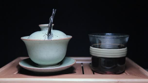 Tea Cup Butterfly Bamboo Desk Dark Background Footage — Stock Video