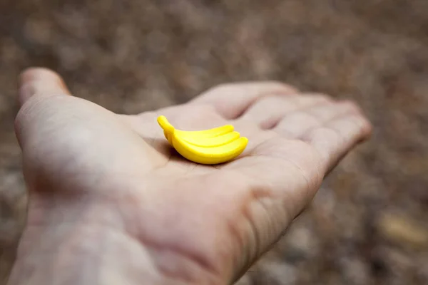 banana man hand stone background