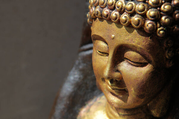 gold buddha face statue wall background  