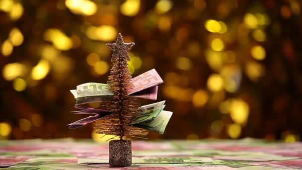 Tannenbaum Geld Tisch Gold Bokeh Filmmaterial — Stockvideo