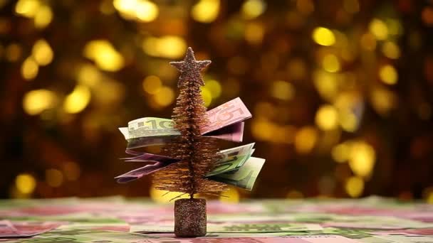 Tannenbaum Geld Tisch Gold Bokeh Filmmaterial — Stockvideo