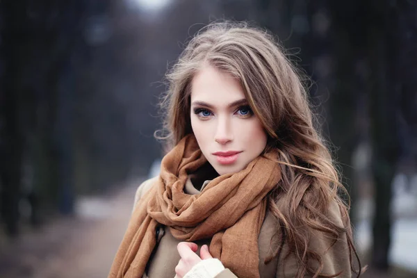 Nice young woman outdoors in park. Perfect female face