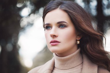 Romantik kadın makyaj ve kıvırcık saçları açık üfleme ile. Güzel kadın yüzü portre