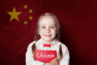 Chinese concept. Little girl student with book against the Chinese flag background. Learn language clipart