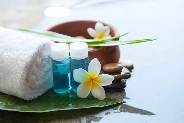 Spa or wellness setting with tropical flower. Body care and spa concept on black background