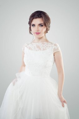 Güzel genç kadın gelin beyaz dantelli elbise giyiyor makyaj ve gelin saç kesimi ile. Şirin nişanlı kız