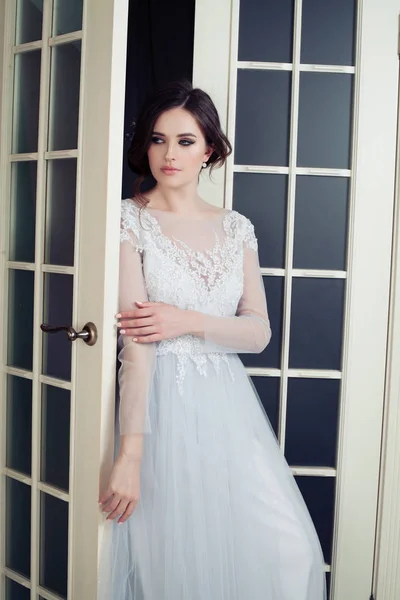 Perfect bride with makeup and bridal hairstyle. Pretty woman in fashionable dress