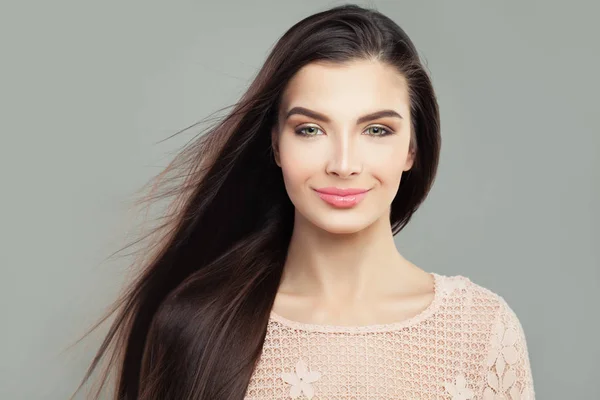 Young woman brunette with long straight blowing hair, fashion portrait