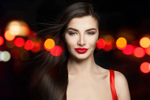 Pretty model woman in red silky dress