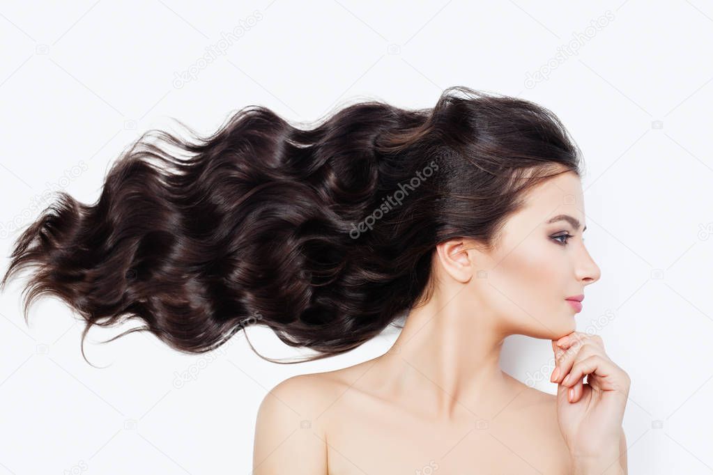 Spa woman with blowing curly hair on white background. Facial treatment, cosmetology, haircare and wellness concept