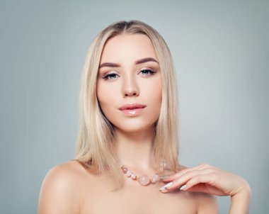 Glamorous jewelry model. Perfect blonde woman with pink gem necklace portrait  clipart