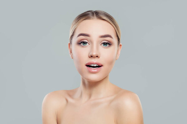 Young woman with healthy skin. Surprised girl. Facial treatment and skincare concept