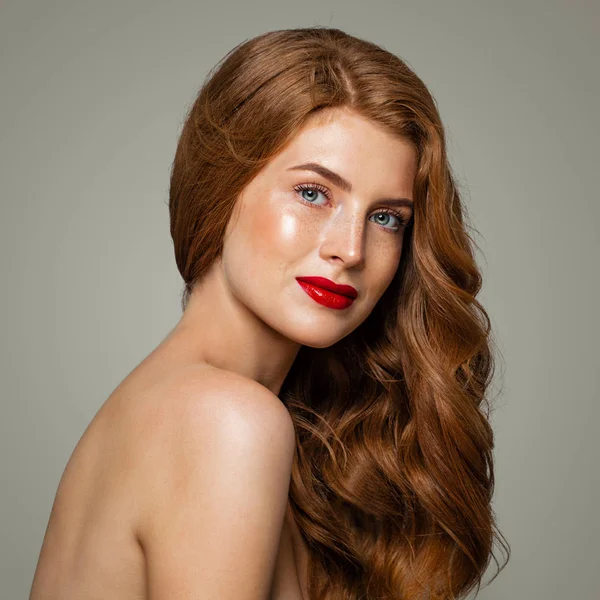 Beautiful red head woman portrait. Red head girl with ginger curly hairstyle