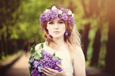 Güzel bir kadın yüzü açık havada dikey. Bahar çiçekleri ile kız