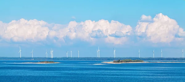 Wind farm nature background with wind turbine, blue sky and sea. Wind turbine landscape