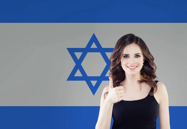 美丽的愉快的年轻妇女在以色列旗子背景之下. — 图库照片