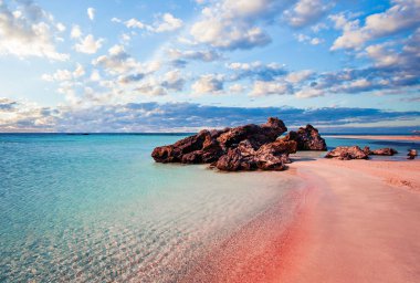 Crete skyline. Elafonissi beach with pink sand against blue sky  clipart